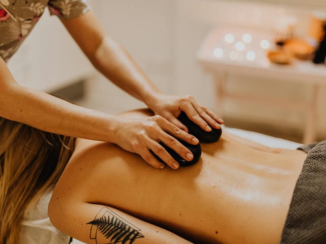 a tattooed woman having a massage