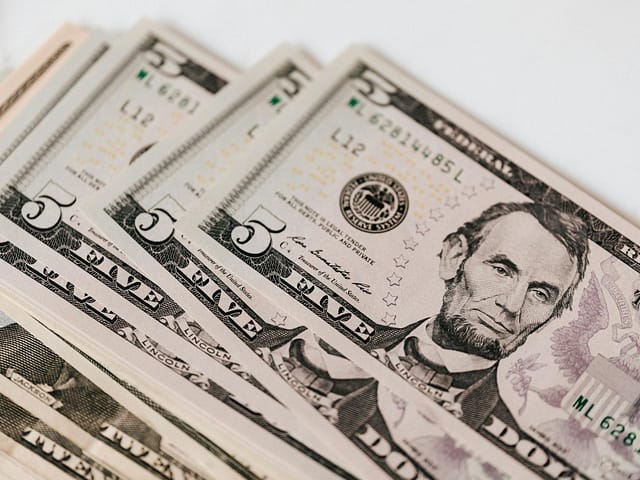 heap of money on white surface